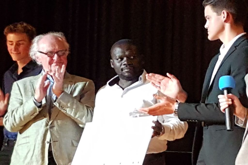 Hamilton Ayiera nimmt einen Scheck in Höhe von 10.000 Euro für seine Initiative im Slum Korogocho in Nairobi entgegen. © Tom Rübenach